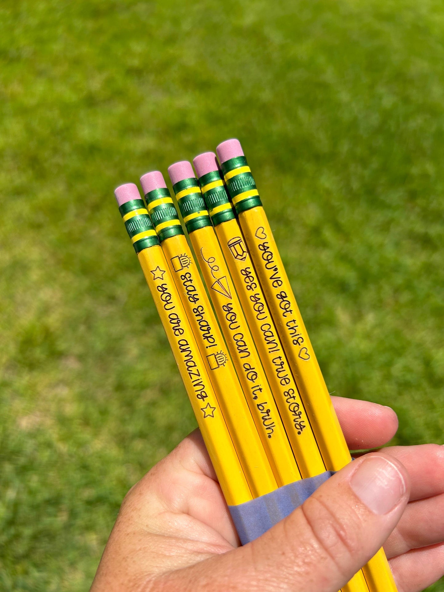 Set of 5 engraved pencils in pastel colors, featuring motivational phrases: "You are amazing," "Stay Sharp," "You can do it, bruh," "Yes you can! True story," and "You've got this." Ideal for back-to-school gifts.