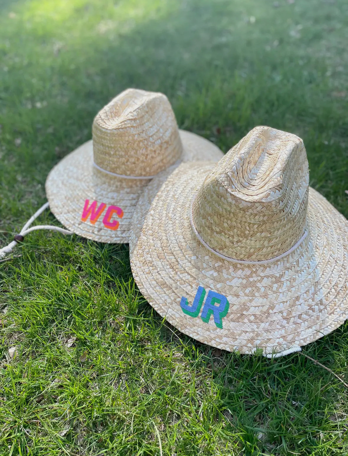 A stylish beach straw hat designed to provide shade at the beach or pool. The hat features a personalized touch with a custom monogram embroidered directly on it, adding a unique flair to your summer look.