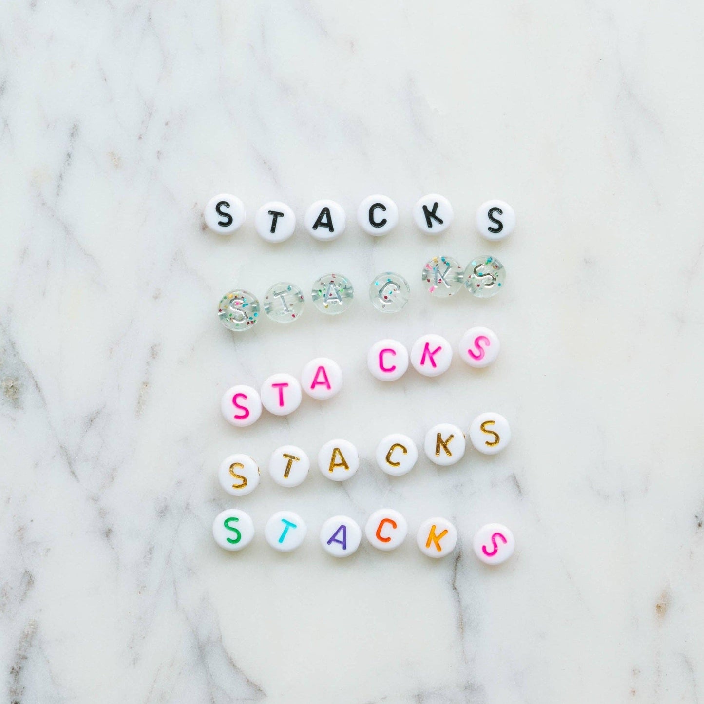 DIY Swiftie friendship bracelet kit featuring light pink and blue heart beads, glitter beads, and clear string. Comes in a silver bag with 'Lover' theme, perfect for creating two custom bracelets. Ideal for Taylor Swift fans and crafting enthusiasts.