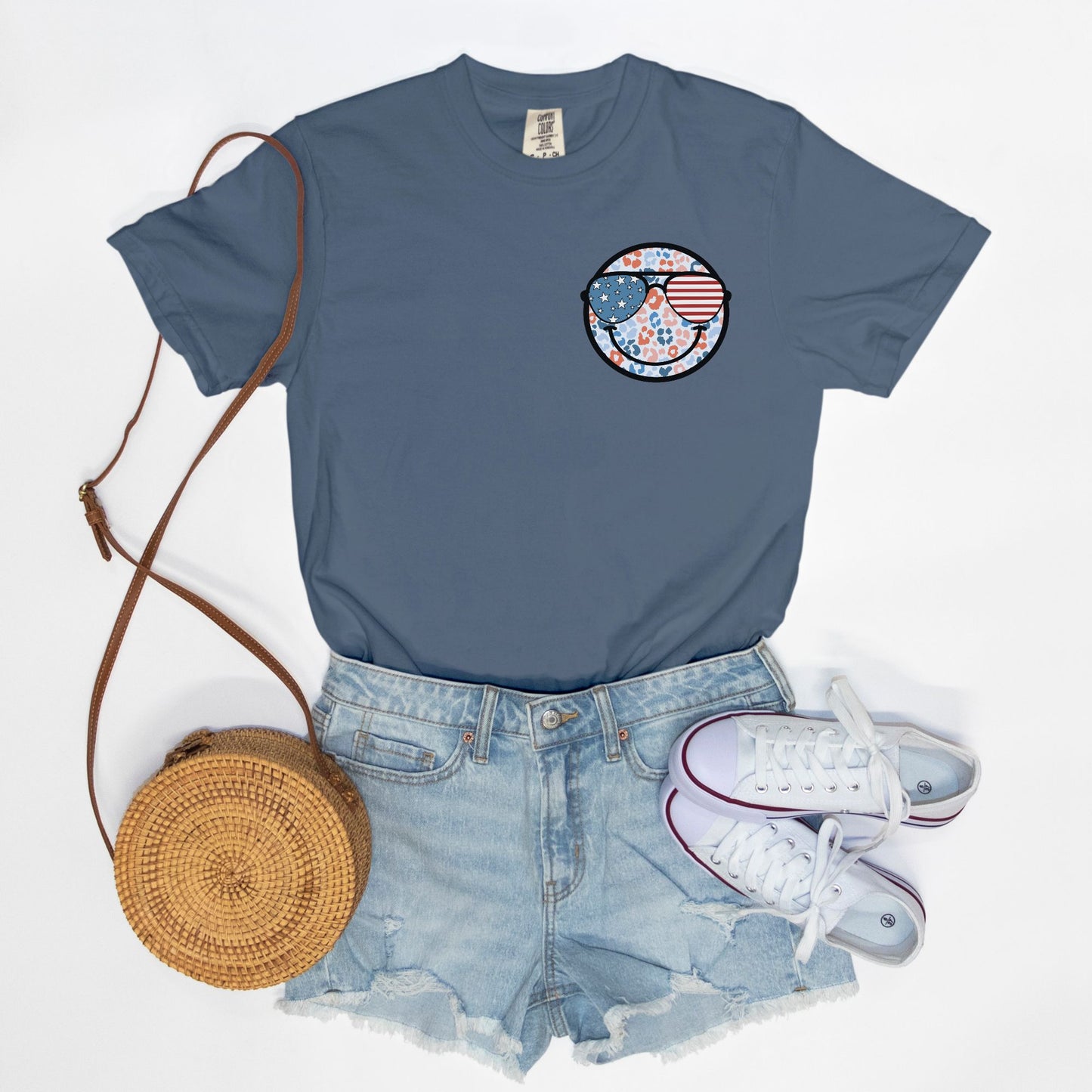 Retro smiley face sunglasses t-shirt featuring a patriotic design with American flag shades. Perfect for 4th of July celebrations, this vintage-style Comfort Colors tee is soft-washed, pre-shrunk, and available in unisex sizes. Show off 90s nostalgia with this fun and comfortable USA flag shirt, ideal for summer BBQs, fireworks, and family gatherings.