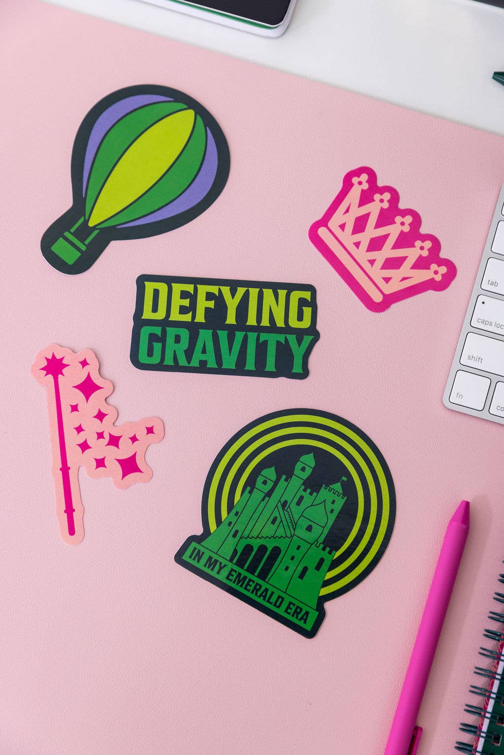 Set of 5 Wicked-themed stickers inspired by the Broadway musical, featuring vibrant designs on durable, high-quality material. Perfect for personalizing laptops, water bottles, and notebooks, or gifting to Broadway fans.
