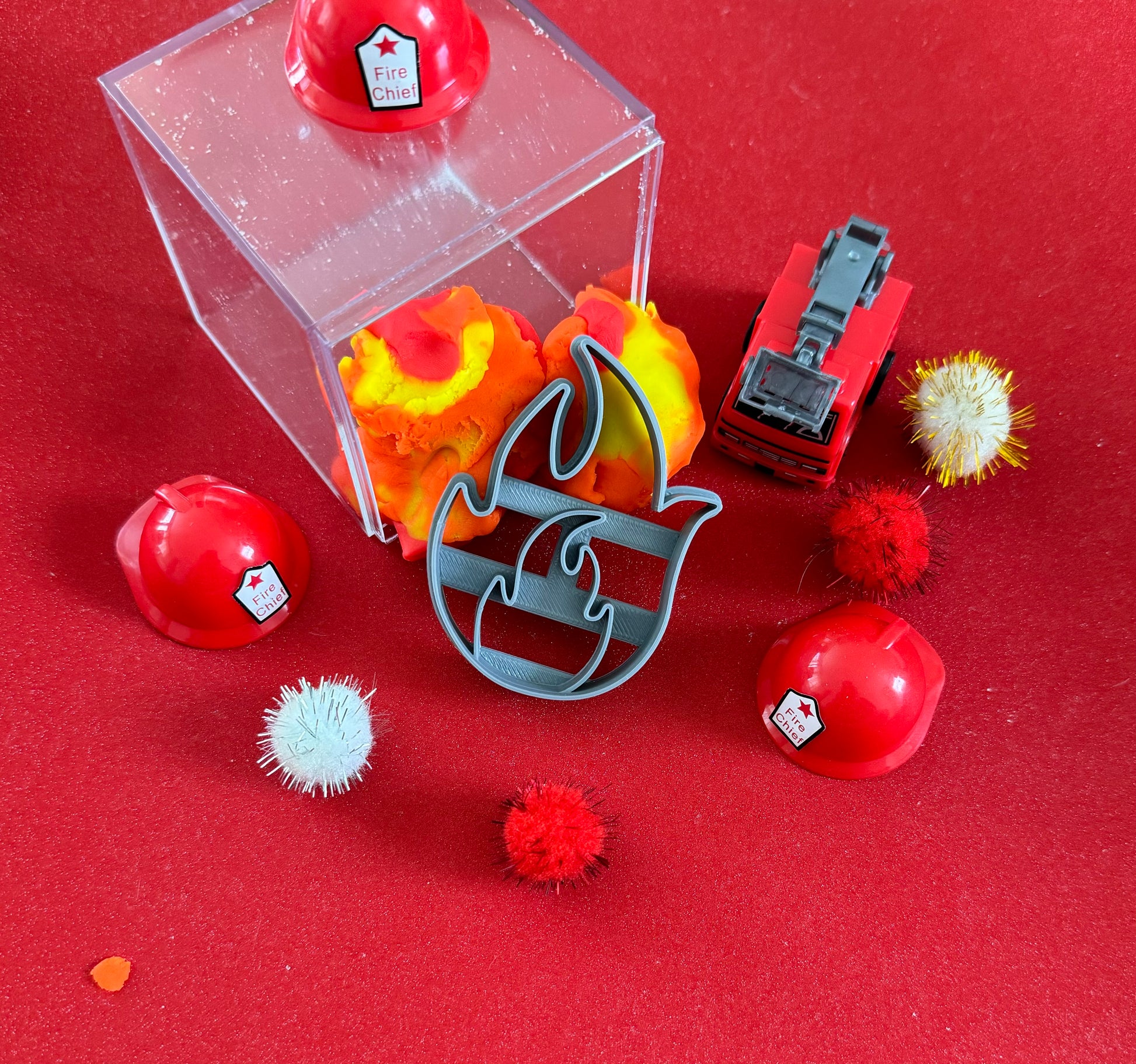 Exciting firefighter-themed sensory kit for kids aged 3 and up, including natural homemade play dough, dough molds, and miniature fire safety toys for imaginative play.