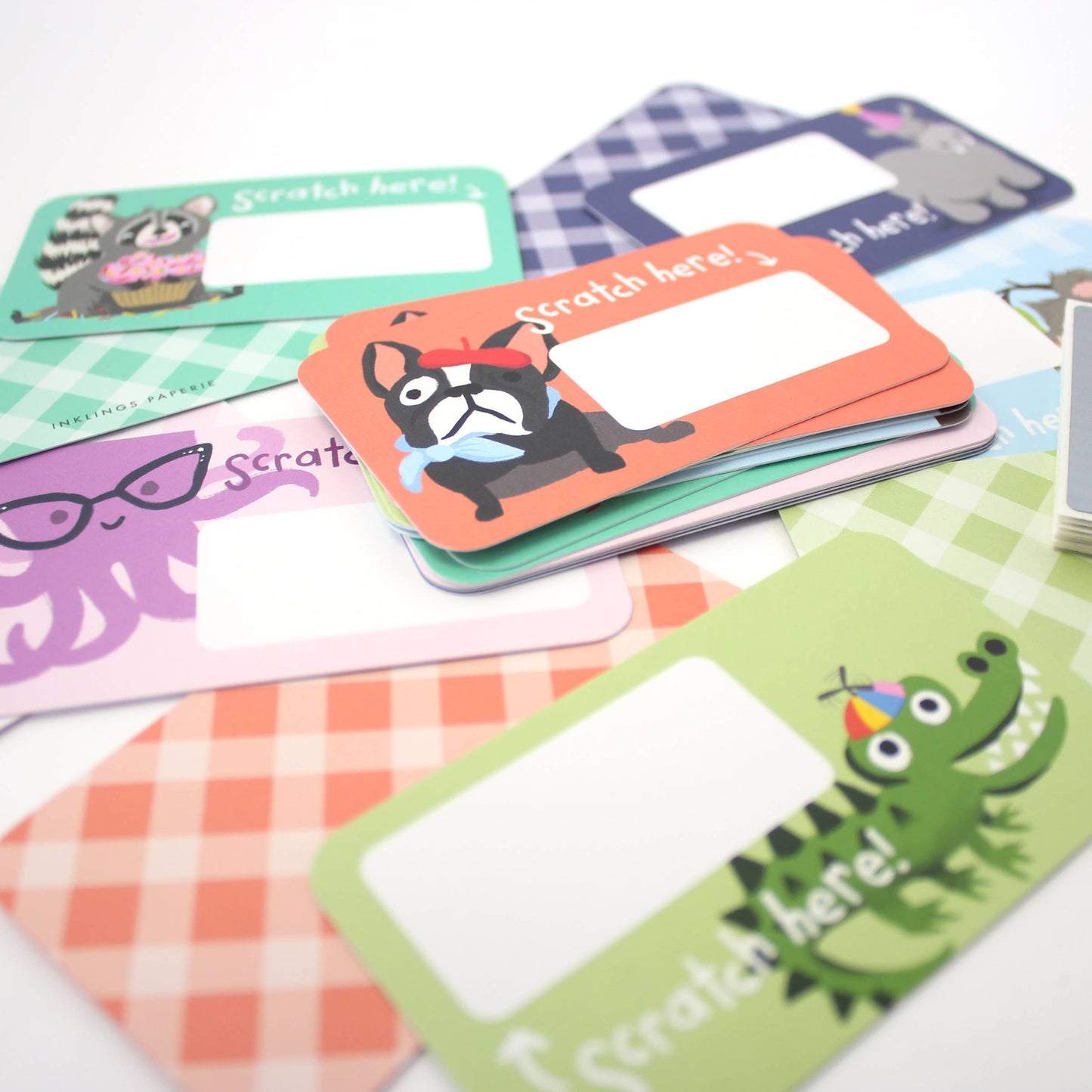Set of 24 assorted scratch-off lunchbox notes measuring 2” x 3.5”, featuring six different animated animal friends designs. Each card allows you to write a personalized message in the blank space, which is then covered with a scratch-off sticker for a fun reveal. Perfect for slipping into lunch bags or coat pockets, these tiny notes come packaged in a clear plastic box, making them an ideal surprise for someone special.