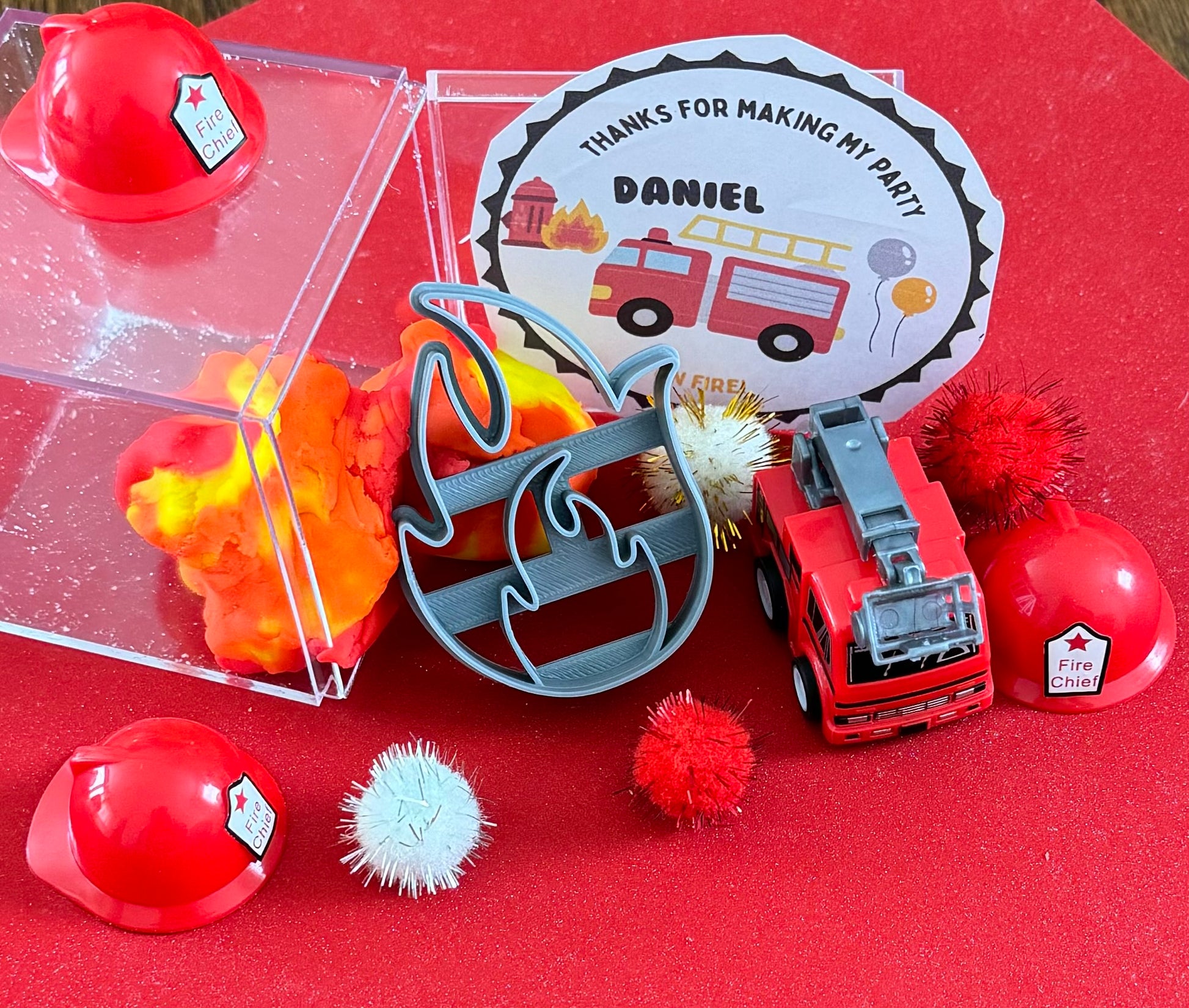Exciting firefighter-themed sensory kit for kids aged 3 and up, including natural homemade play dough, dough molds, and miniature fire safety toys for imaginative play.