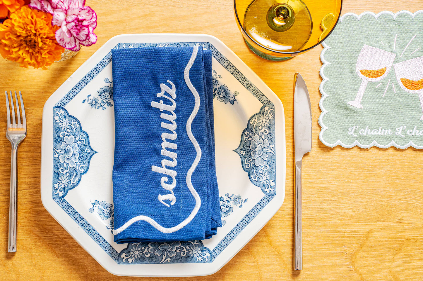 Set of 4 embroidered cotton napkins with a wavy border design, available in Bubbe Blue and Oy Vey Navy. Ideal for dinner parties, these 15-inch napkins are perfect for wiping up schmutz. Machine washable and ready for gifting, wrapped in ribbon.