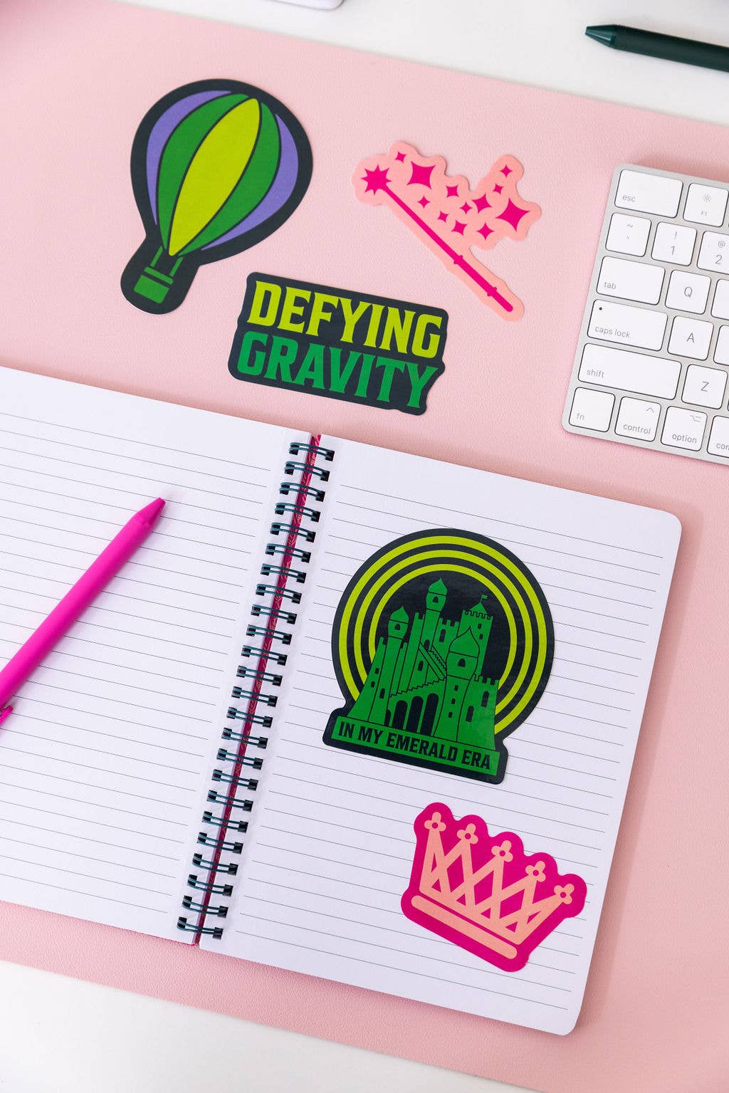 Set of 5 Wicked-themed stickers inspired by the Broadway musical, featuring vibrant designs on durable, high-quality material. Perfect for personalizing laptops, water bottles, and notebooks, or gifting to Broadway fans.