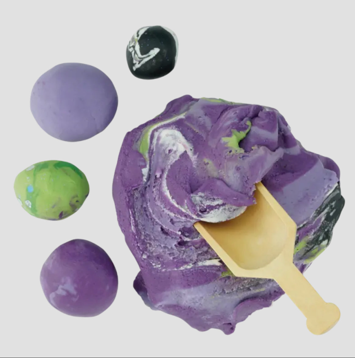 Land of Dough natural sculpting dough with coconut oil and essential oils, perfect for little hands to shape and create. Includes 7oz carton with a wooden spoon. Colors include pink, blue green, and light blue with compostable glitter. Reusable and air-dryable.