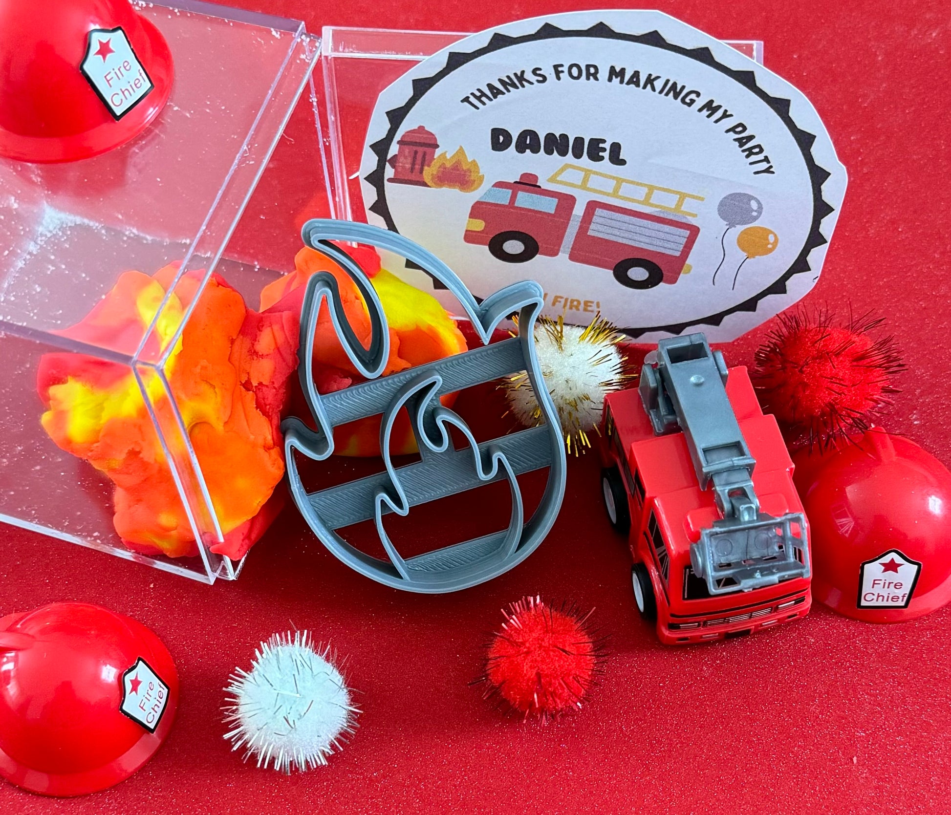 Exciting firefighter-themed sensory kit for kids aged 3 and up, including natural homemade play dough, dough molds, and miniature fire safety toys for imaginative play.