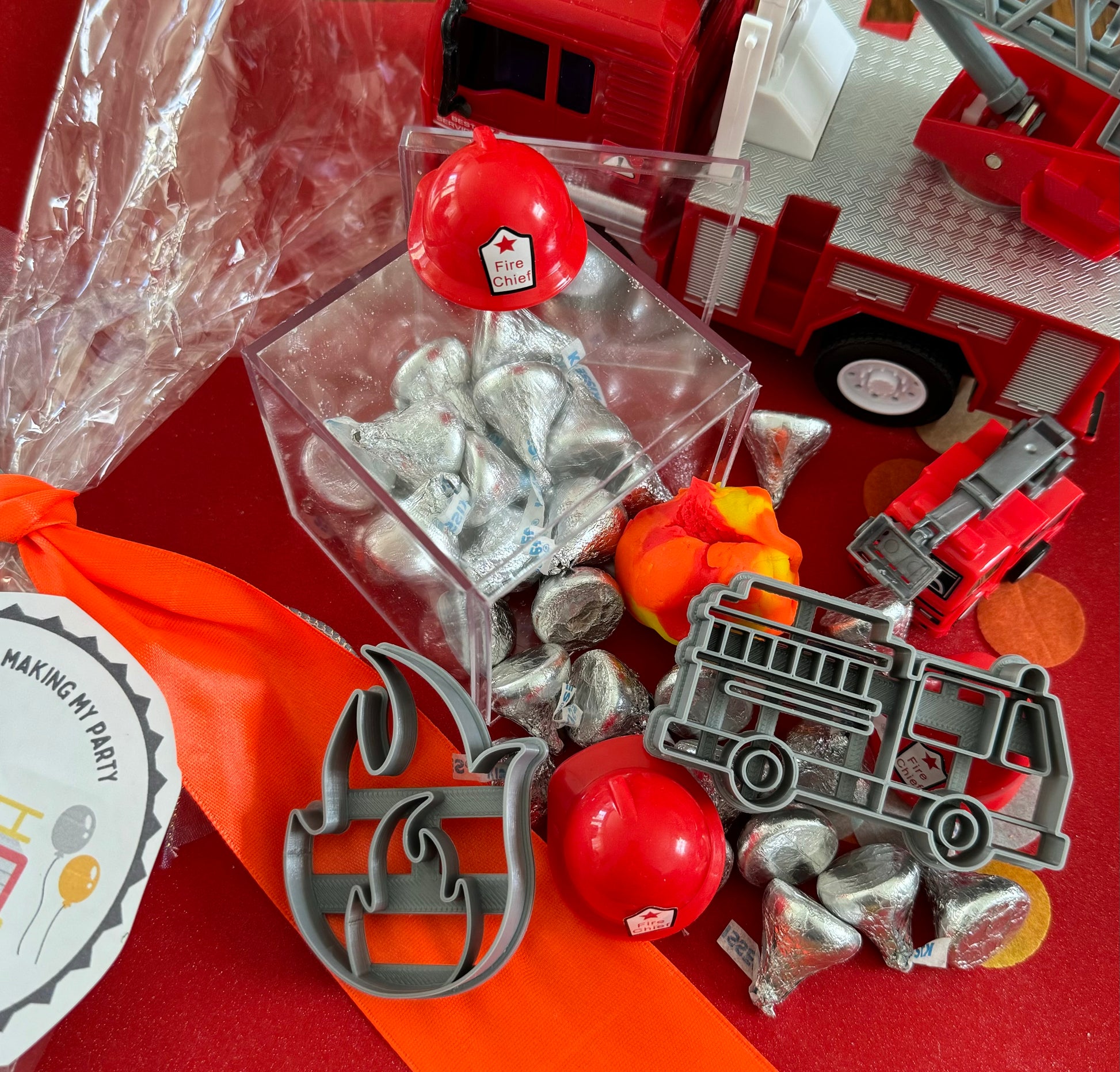 Exciting firefighter-themed sensory kit for kids aged 3 and up, including natural homemade play dough, dough molds, and miniature fire safety toys for imaginative play.