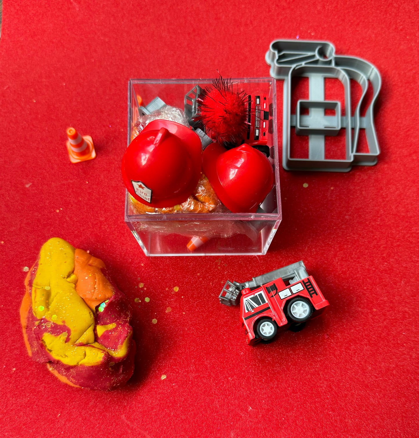 Exciting firefighter-themed sensory kit for kids aged 3 and up, including natural homemade play dough, dough molds, and miniature fire safety toys for imaginative play.