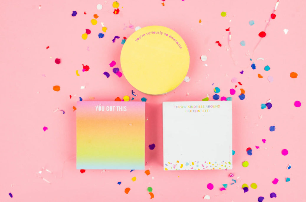 Colorful 3.5" x 3.5" sticky note pad with 300 sheets, imprinted with 'Throw Kindness Around Like Confetti.' Features a sticky adhesive backing and comes in shrink-wrap packaging. Confetti acrylic note holder sold separately.