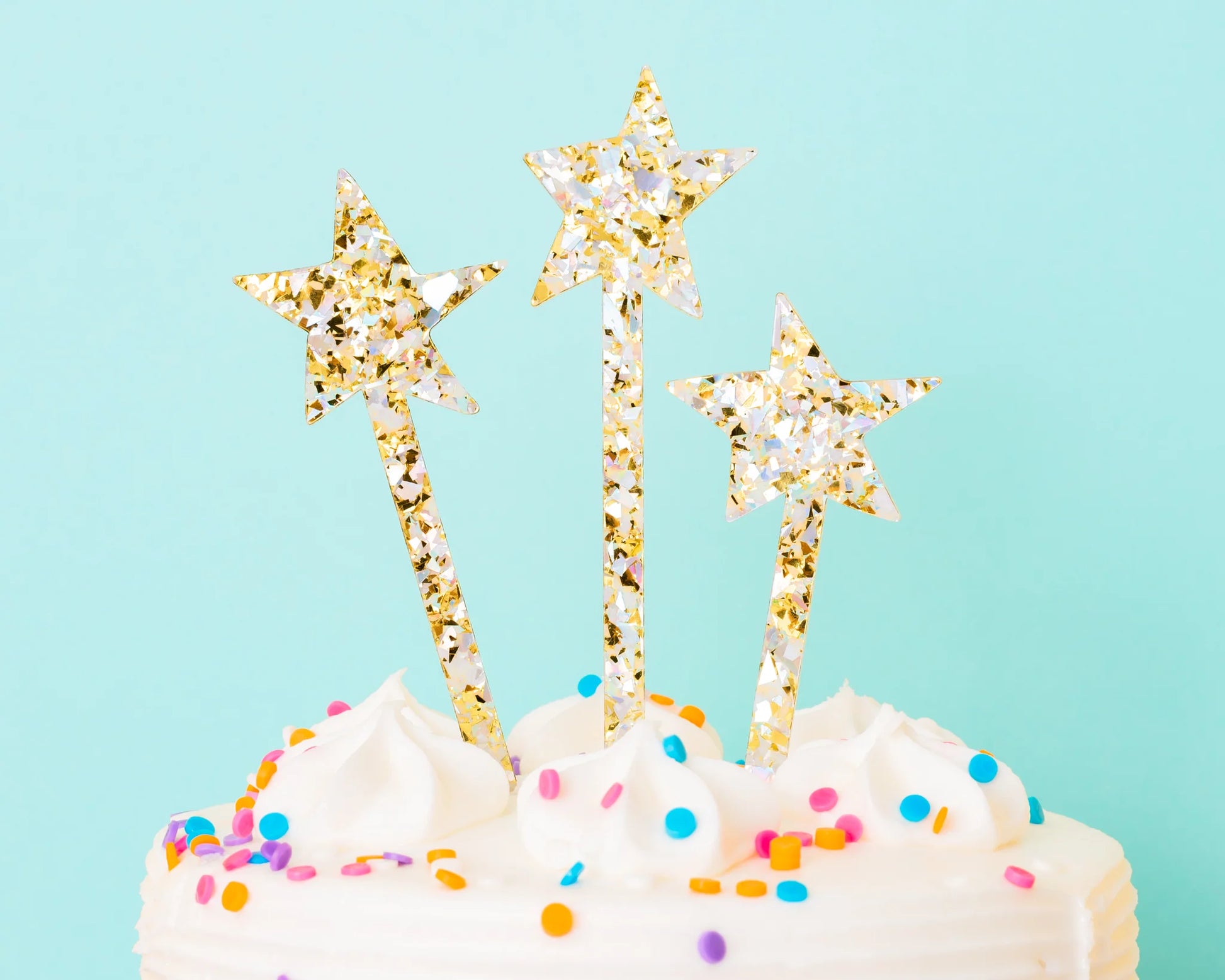 Oversized star-shaped confetti cake toppers in pearl and gold, ideal for Sweet 16 and Quinceanera.