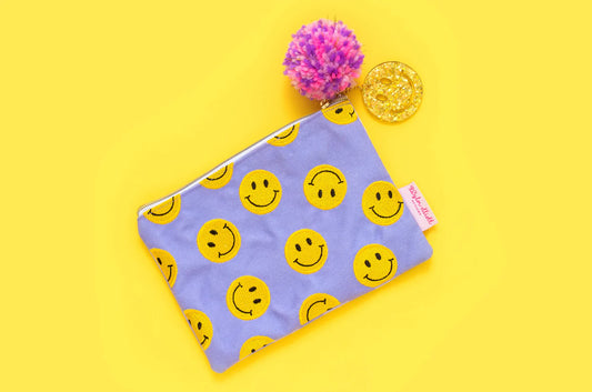 Set of 4 smiley pouches with purple gingham, perfect for organizing cosmetics, pencils, and more.