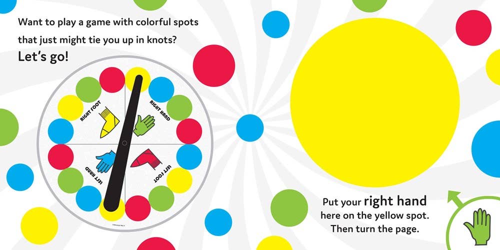 Child placing hand on red dot in interactive book
