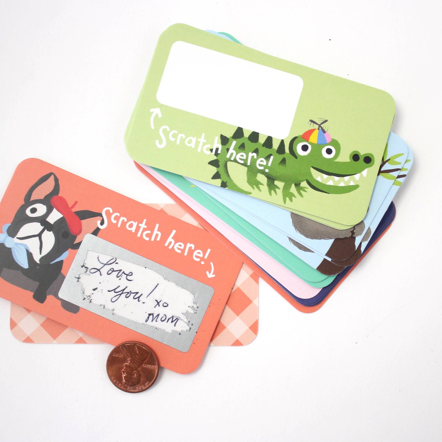 Set of 24 assorted scratch-off lunchbox notes measuring 2” x 3.5”, featuring six different animated animal friends designs. Each card allows you to write a personalized message in the blank space, which is then covered with a scratch-off sticker for a fun reveal. Perfect for slipping into lunch bags or coat pockets, these tiny notes come packaged in a clear plastic box, making them an ideal surprise for someone special.