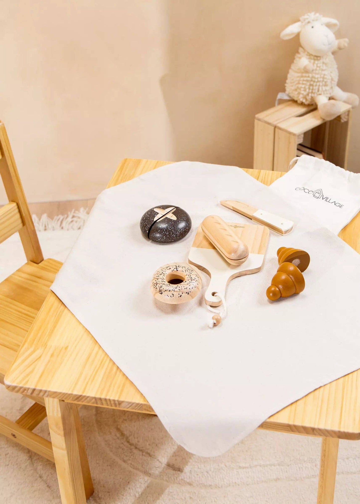 Wooden Bakery Playset for kids with baguette, croissant, pumpernickel, bagel, cutting board, and knife. Ideal for imaginative market play, helping children learn about different bread types, healthy eating, and colors. Perfect for pretend play with kitchen and market sets