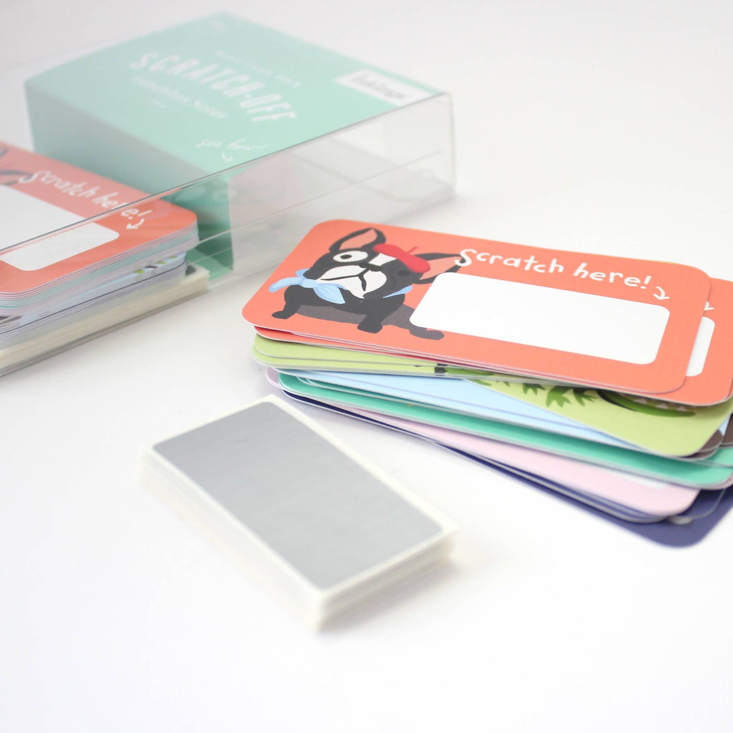 Set of 24 assorted scratch-off lunchbox notes measuring 2” x 3.5”, featuring six different animated animal friends designs. Each card allows you to write a personalized message in the blank space, which is then covered with a scratch-off sticker for a fun reveal. Perfect for slipping into lunch bags or coat pockets, these tiny notes come packaged in a clear plastic box, making them an ideal surprise for someone special.