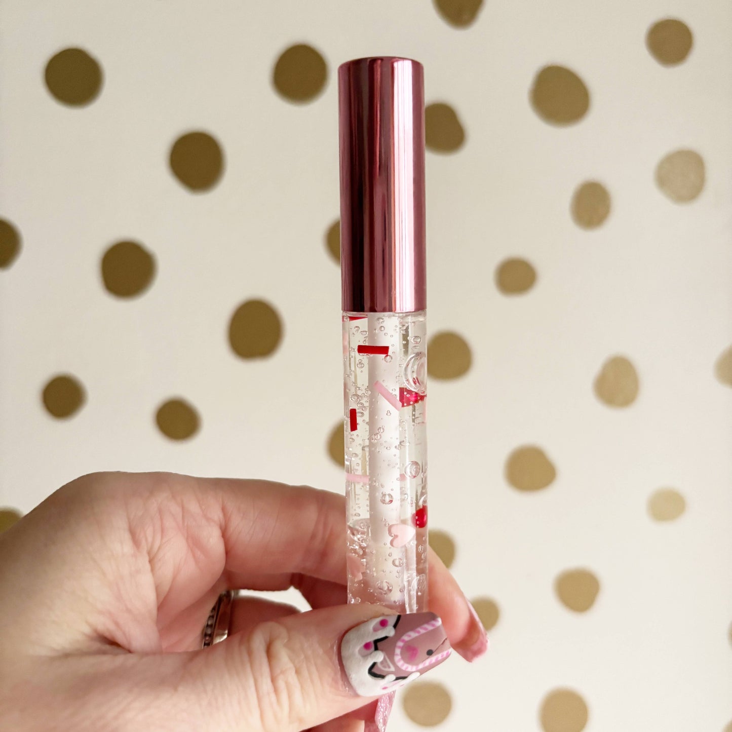 Strawberry-flavored heart wand lip gloss with red & pink confetti, moisturizing, perfect Valentine gift.