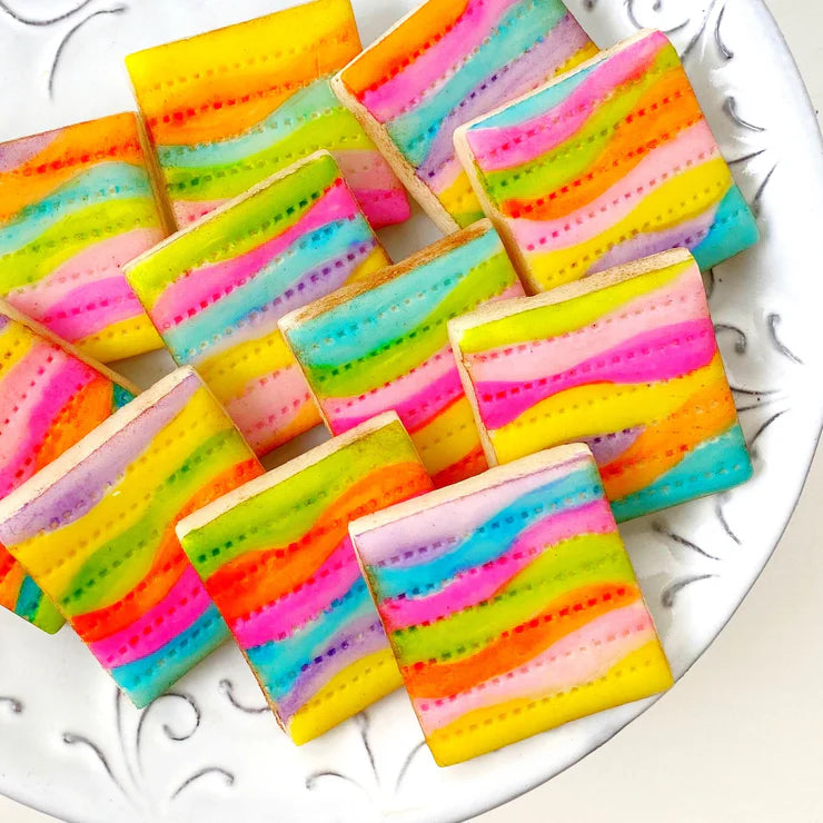 Fantasy rainbow matzah tiles – hand-painted marzipan treats in a 10-piece gift box for Passover.