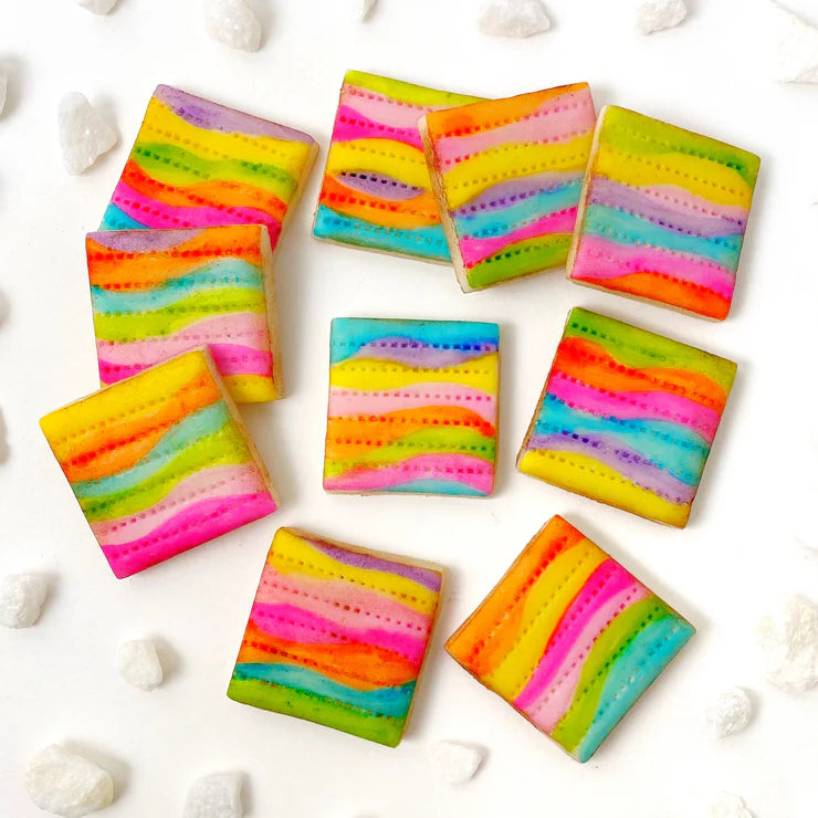 Rainbow Delight hand-painted matzah tiles – colorful marzipan treats for Passover Seder.