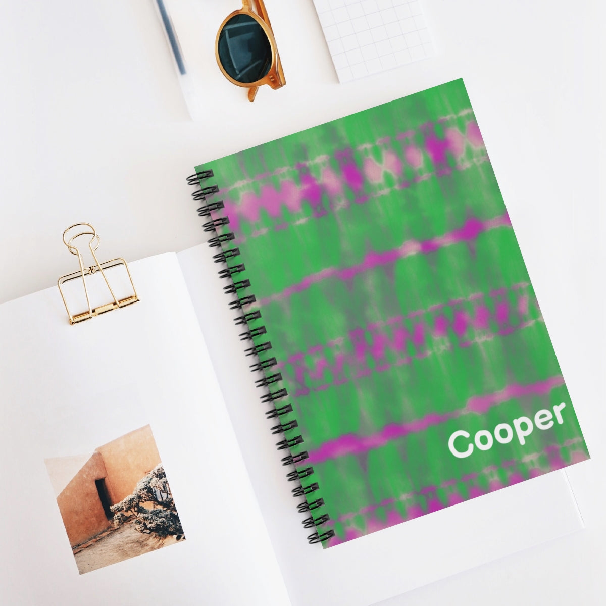 Personalized green tie-dye journal with custom font and color. Features 118 ruled pages, metal spiral binding, and measures 6" x 8" (15.2 x 20.3 cm) Ideal for adding a unique touch to your writing.