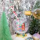 Shake up your holiday drinks with this 12 oz snow globe-shaped cup, featuring a holiday village and shakeable confetti. Perfect for festive parties or as a unique gift. BPA-free and hand wash only. Dimensions: 10.5" x 5" x 5" (including straw).