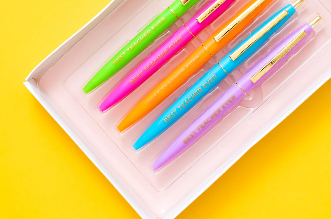 Set of 5 colorful "Best Teacher Ever" pens with matching ink colors. Medium ballpoint pens in a white gift box with gold foil dots, perfect for teacher appreciation gifts.