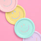 Pastel party supply kit with plates, napkins, balloons, straws, and curtains