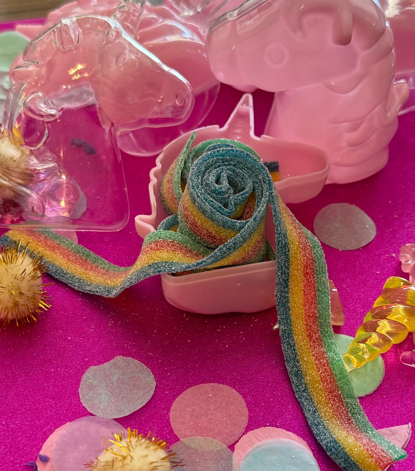 Unicorn-themed candy favor in a magical candy box featuring rainbow sour candy tails. Perfect for birthday parties and kids' celebrations. Enjoy a delightful sensory adventure with this fun and whimsical treat. Color may vary from photos.