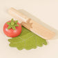 Market basket playset with wooden veggies and a knife, perfect for toddler pretend kitchen fun.