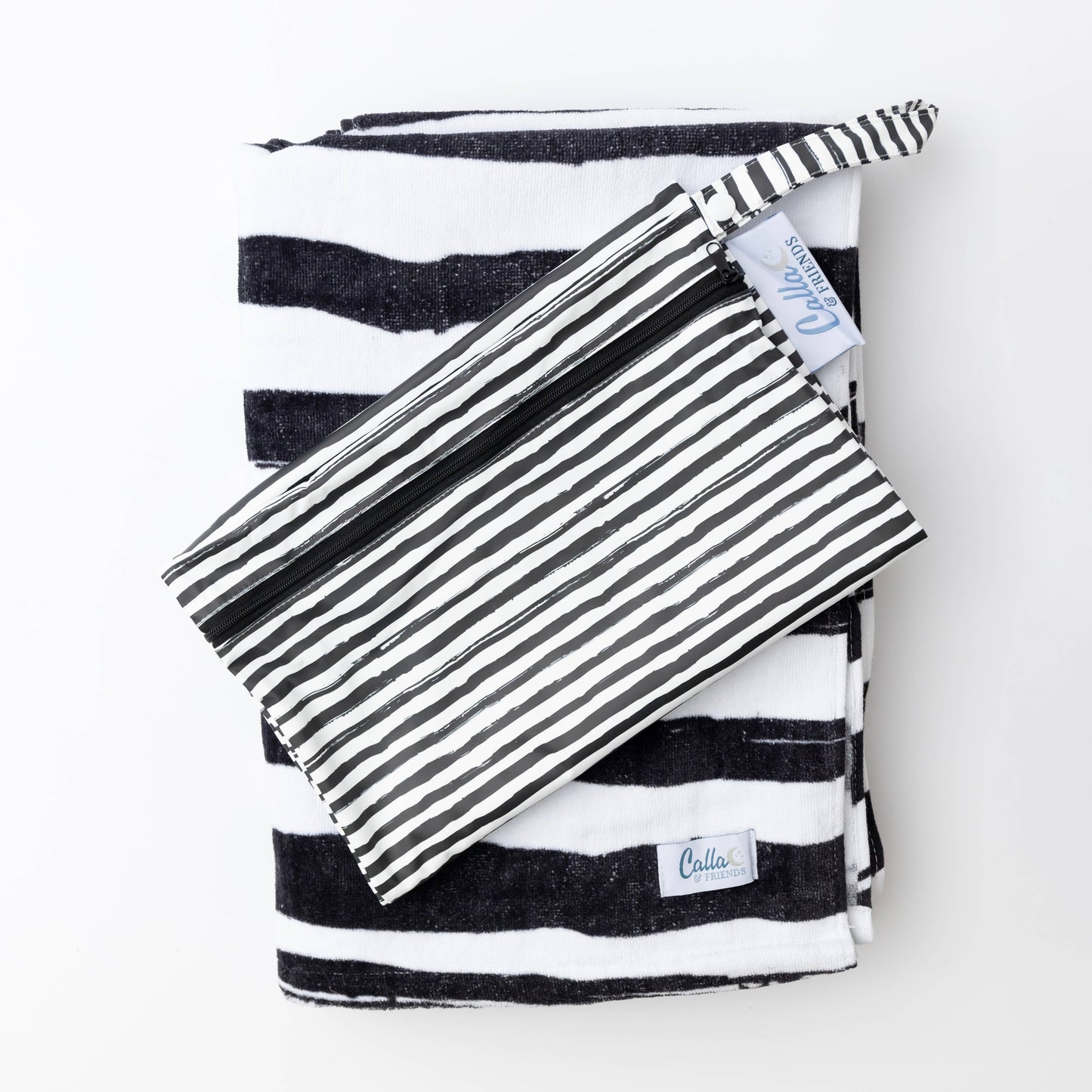 Kenzie Beach Towel and wet bag set laid out beside pool toys