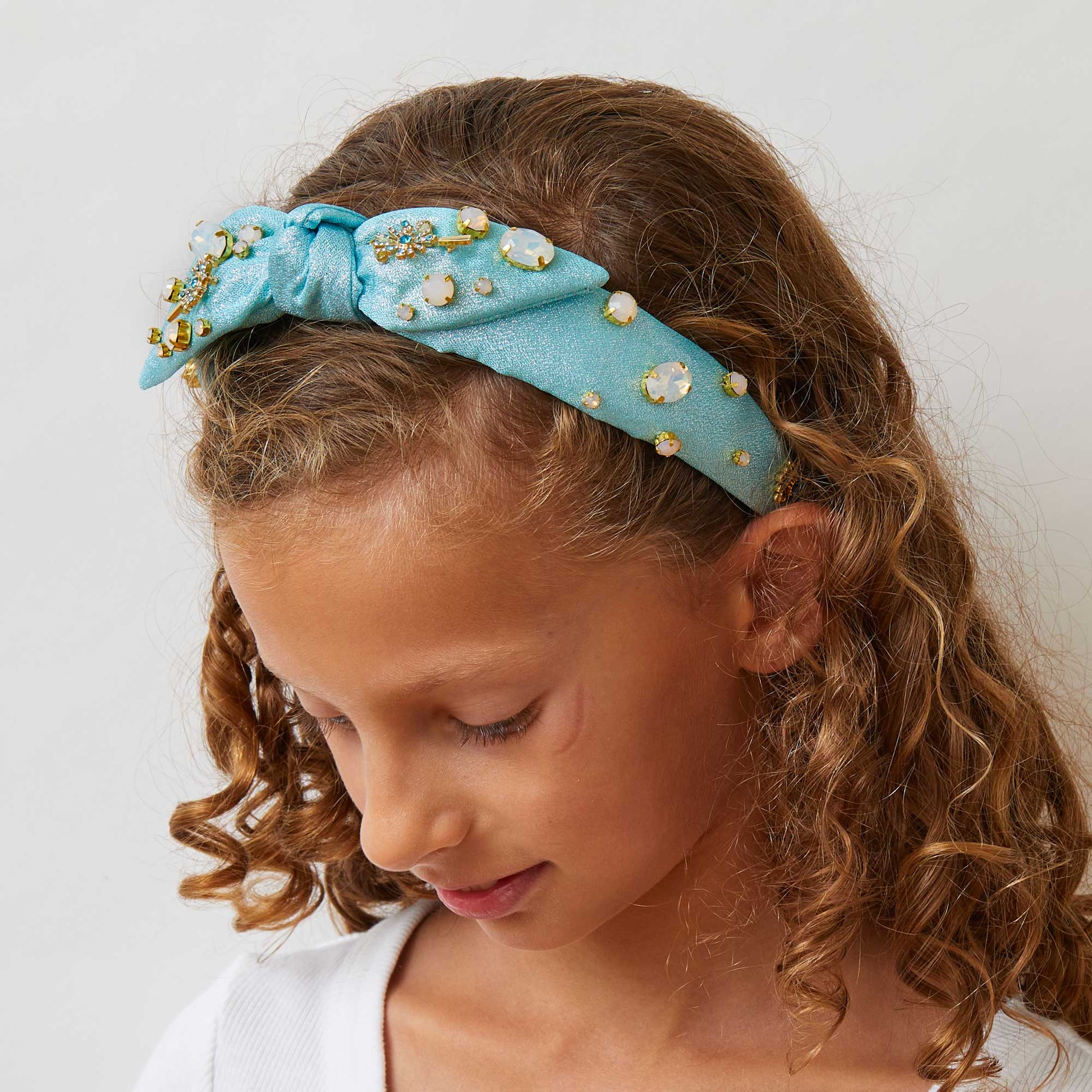 Lele Sadoughi x Wicked Headband, NY Broadway Collaboration, Wicked 25th Anniversary Accessories, Glinda-Inspired Magical Wand Design, Bubble Blue Poly Blend Headband, Hand-Embellished Oval Opals & Round Crystals, 14k Gold-Plated Wand Charms, Comfort Fit Band for Ages 3-9, Trademark Logo Charm, Spot Clean, Custom Collaboration Pouch Included, Stylish & Comfortable NYC Design, High-Quality Fabrics & Hand-Sewn Trims, Iconic Wicked Accessories, Perfect Gift for Broadway Fans, Unique Collaboration Headband, Lele
