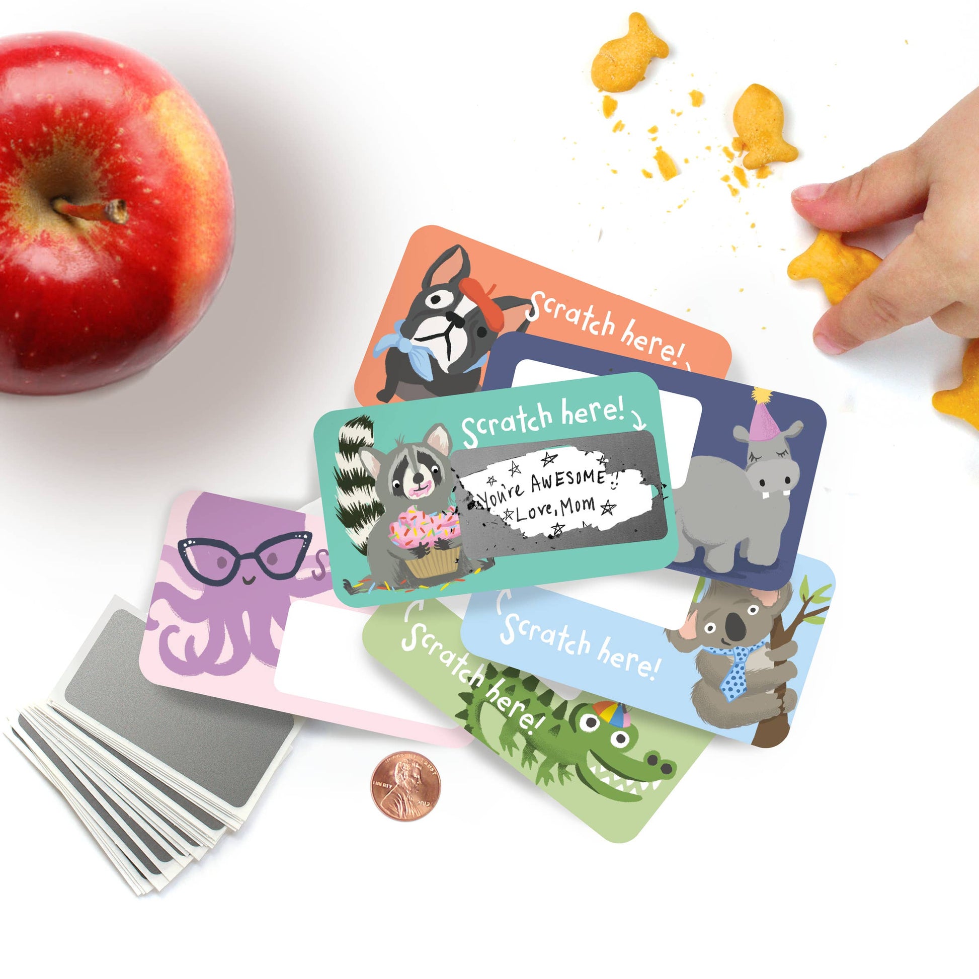 Set of 24 assorted scratch-off lunchbox notes measuring 2” x 3.5”, featuring six different animated animal friends designs. Each card allows you to write a personalized message in the blank space, which is then covered with a scratch-off sticker for a fun reveal. Perfect for slipping into lunch bags or coat pockets, these tiny notes come packaged in a clear plastic box, making them an ideal surprise for someone special. 