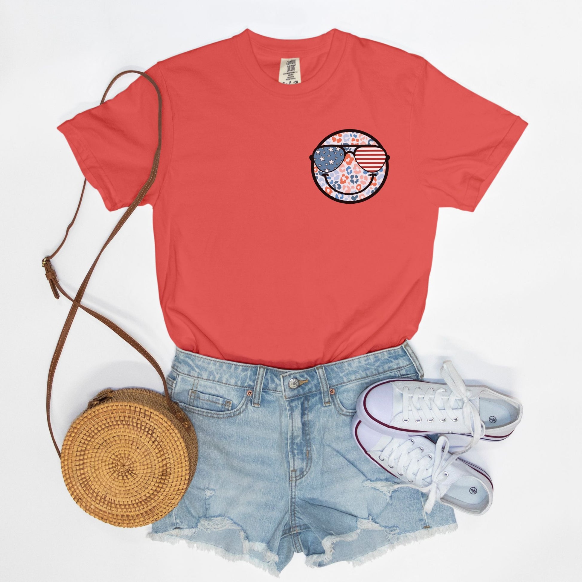 Retro smiley face sunglasses t-shirt featuring a patriotic design with American flag shades. Perfect for 4th of July celebrations, this vintage-style Comfort Colors tee is soft-washed, pre-shrunk, and available in unisex sizes. Show off 90s nostalgia with this fun and comfortable USA flag shirt, ideal for summer BBQs, fireworks, and family gatherings.