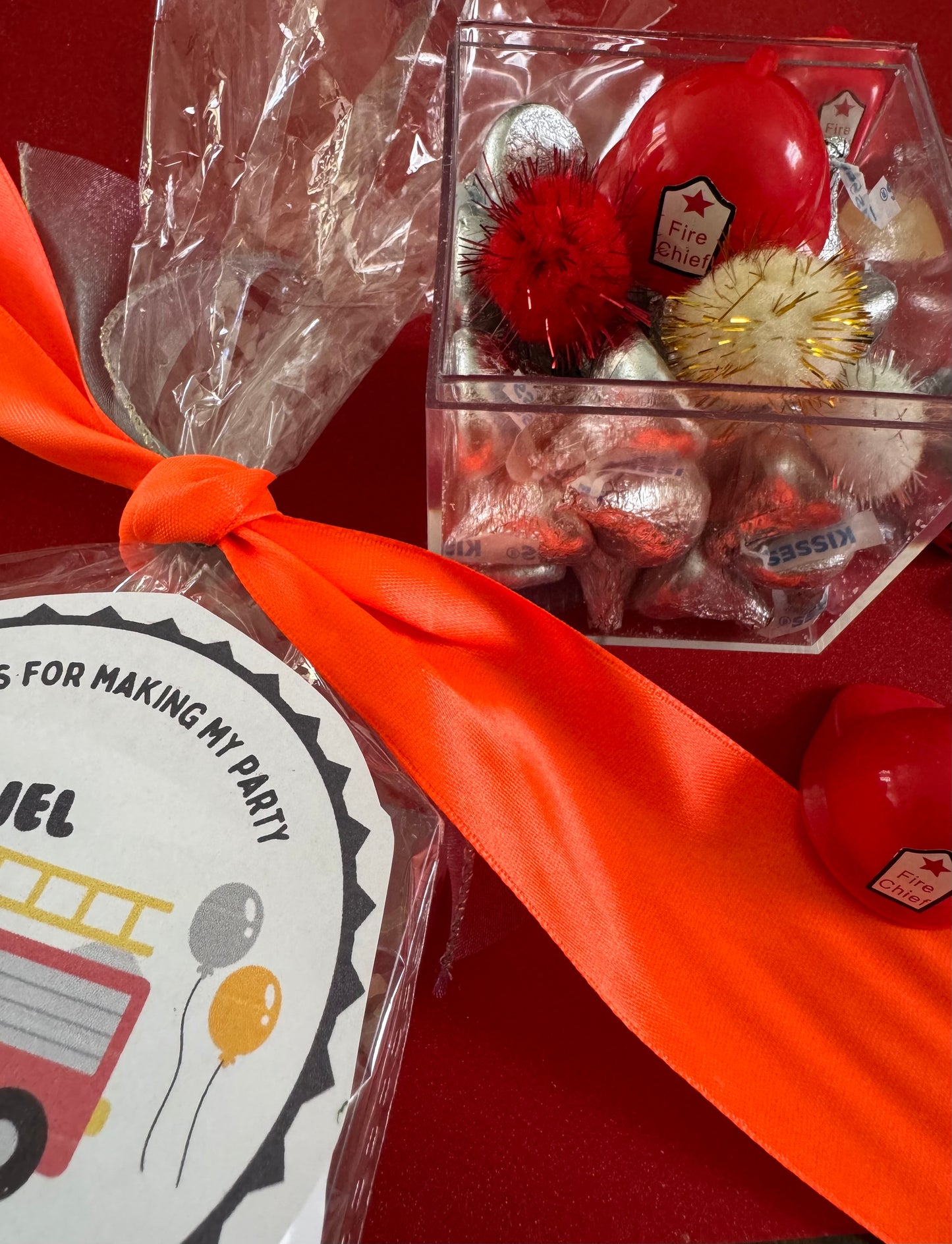 Delight in our Firetruck Themed candy favor, perfect for birthdays and firehouse play dates. This magical treat comes in a perfectly sized square plastic box filled with chocolate 'kisses' themed with firetruck labels. Each box is wrapped in cellophane and can include a thank you label. Explore more candy container options. Ideal for fire truck, firefighter, and tractor-themed parties, ensuring a delicious and fun addition to your celebration.