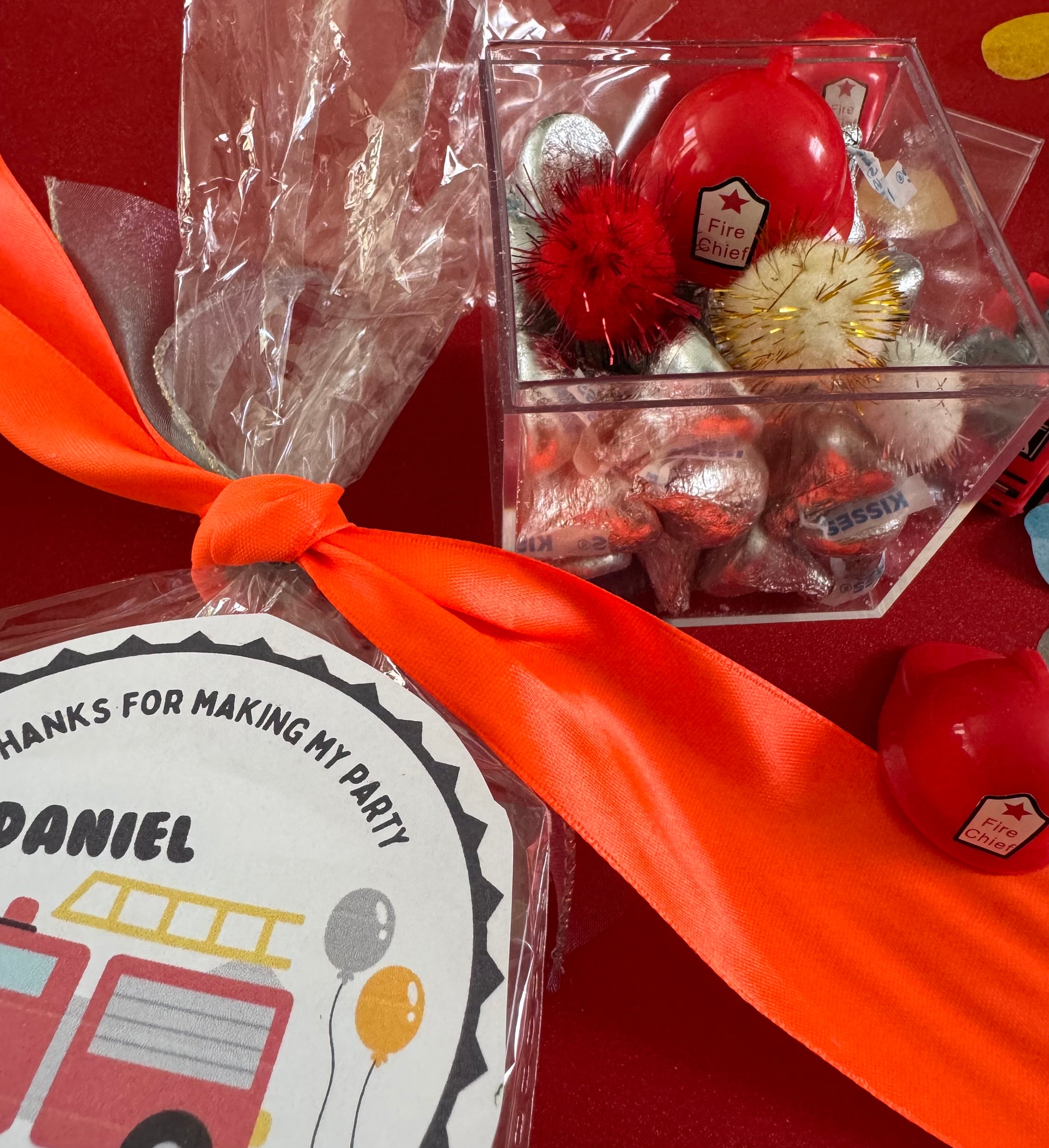 Delight in our Firetruck Themed candy favor, perfect for birthdays and firehouse play dates. This magical treat comes in a perfectly sized square plastic box filled with chocolate 'kisses' themed with firetruck labels. Each box is wrapped in cellophane and can include a thank you label. Explore more candy container options. Ideal for fire truck, firefighter, and tractor-themed parties, ensuring a delicious and fun addition to your celebration.