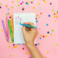 Set of 5 colorful "Best Teacher Ever" pens with matching ink colors. Medium ballpoint pens in a white gift box with gold foil dots, perfect for teacher appreciation gifts.