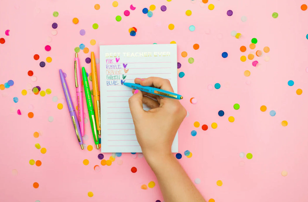 Set of 5 colorful "Best Teacher Ever" pens with matching ink colors. Medium ballpoint pens in a white gift box with gold foil dots, perfect for teacher appreciation gifts.