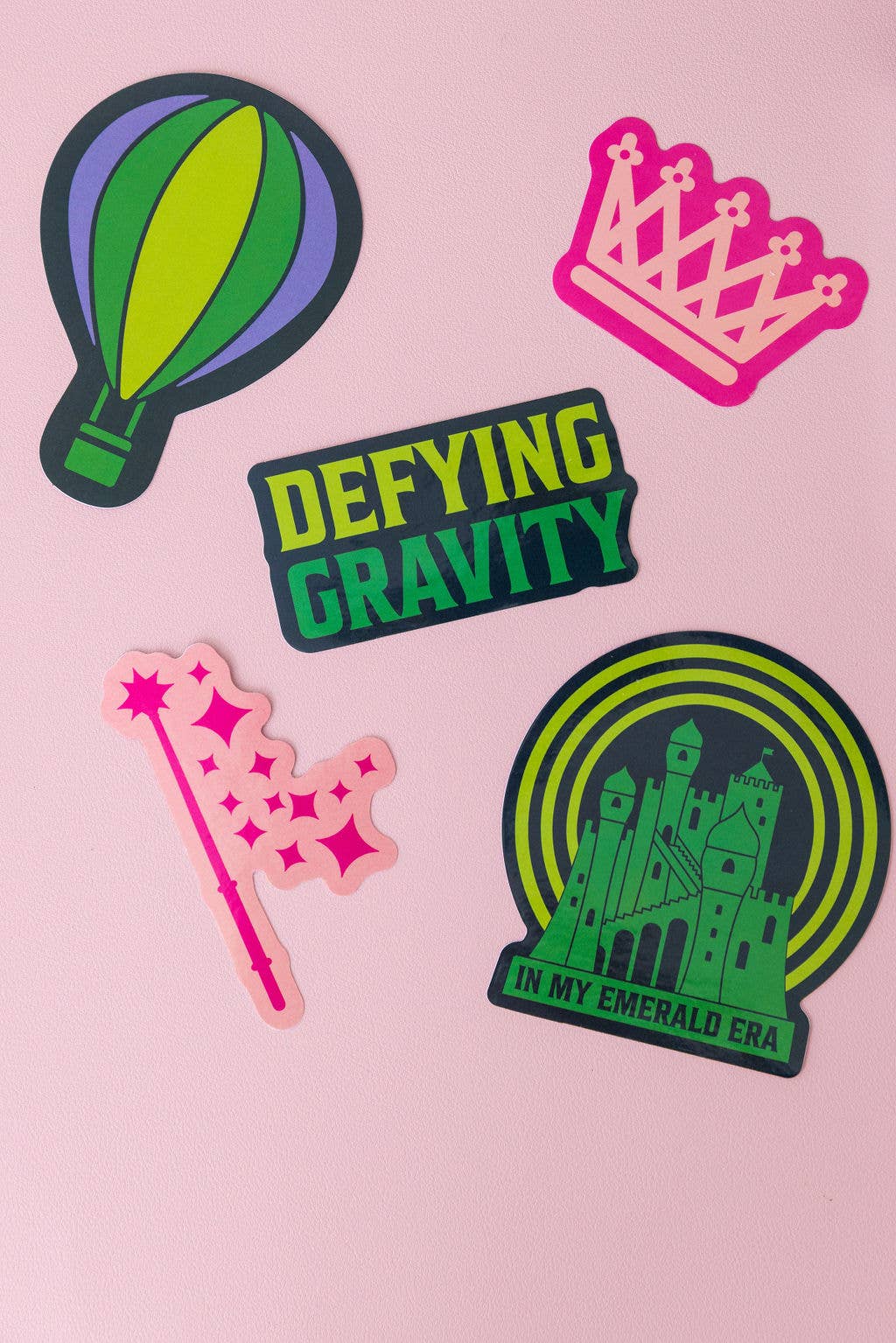 Set of 5 Wicked-themed stickers inspired by the Broadway musical, featuring vibrant designs on durable, high-quality material. Perfect for personalizing laptops, water bottles, and notebooks, or gifting to Broadway fans.