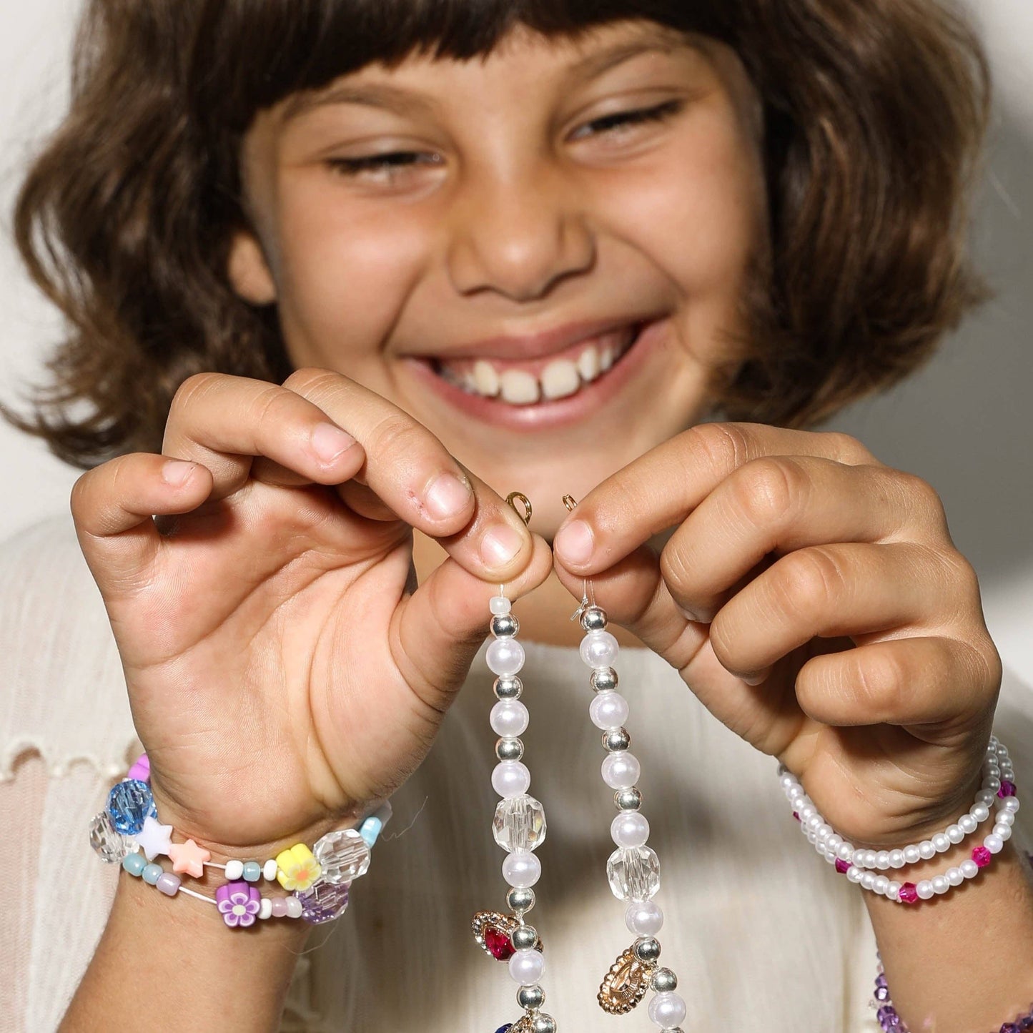 Create a festive Hanukkah stack with this bracelet kit featuring Star of David charms, pearls, and colorful beads. Makes 2+ bracelets (10-year-old sizing). WARNING: Small parts, choking hazard for children under 3. Adult supervision recommended.