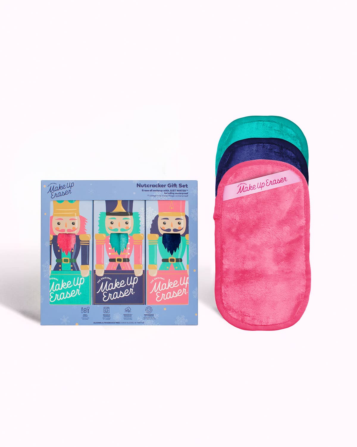 Nutcracker Gift Set by Makeup Eraser, featuring three colorful nutcracker-themed packaging designs. Includes reusable pink and teal makeup remover cloths with a soft, plush texture. Perfect for the holiday season, skincare gifts, or sustainable beauty enthusiasts.