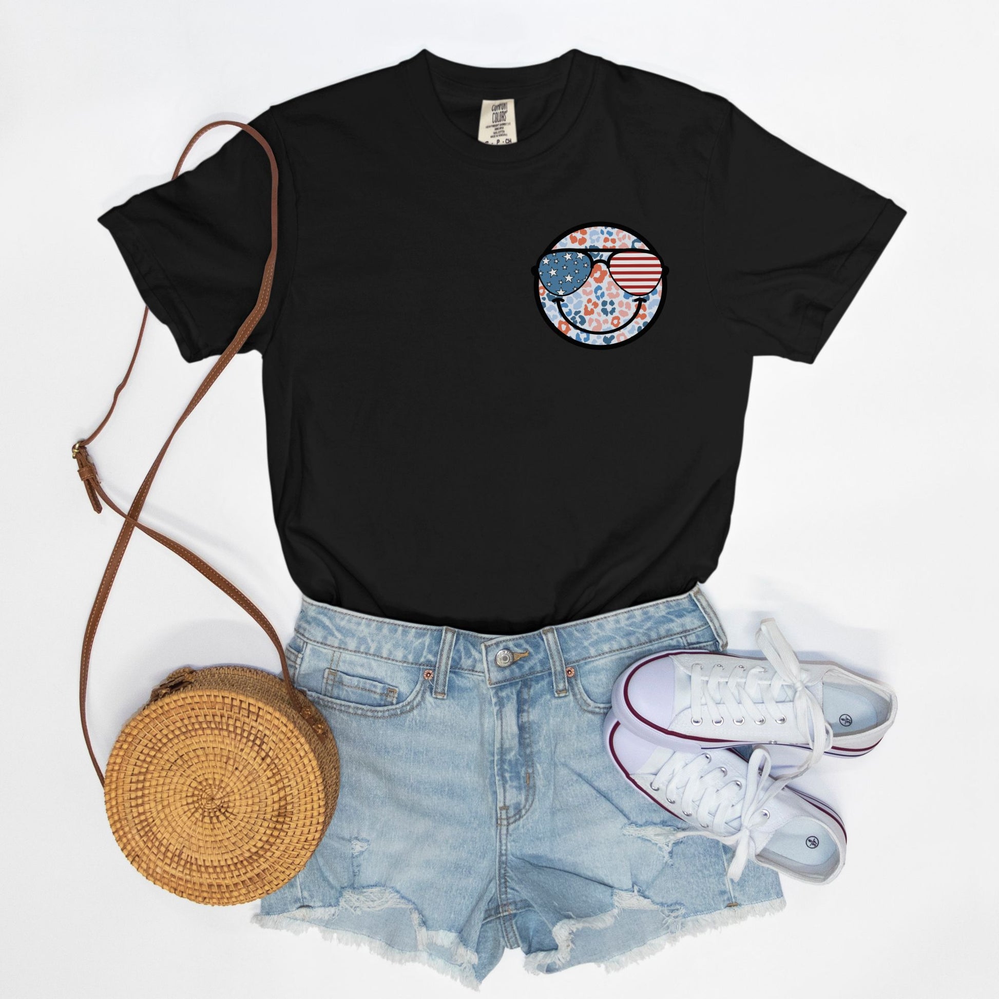 Retro smiley face sunglasses t-shirt featuring a patriotic design with American flag shades. Perfect for 4th of July celebrations, this vintage-style Comfort Colors tee is soft-washed, pre-shrunk, and available in unisex sizes. Show off 90s nostalgia with this fun and comfortable USA flag shirt, ideal for summer BBQs, fireworks, and family gatherings.