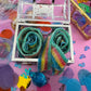 Magical Mermaid Candy favor in a gold or silver treasure chest, featuring rainbow mermaid tail candy with a sour punch. Perfect for under-the-sea or birthday party themes. Colors may vary from photos due to manufacturing differences