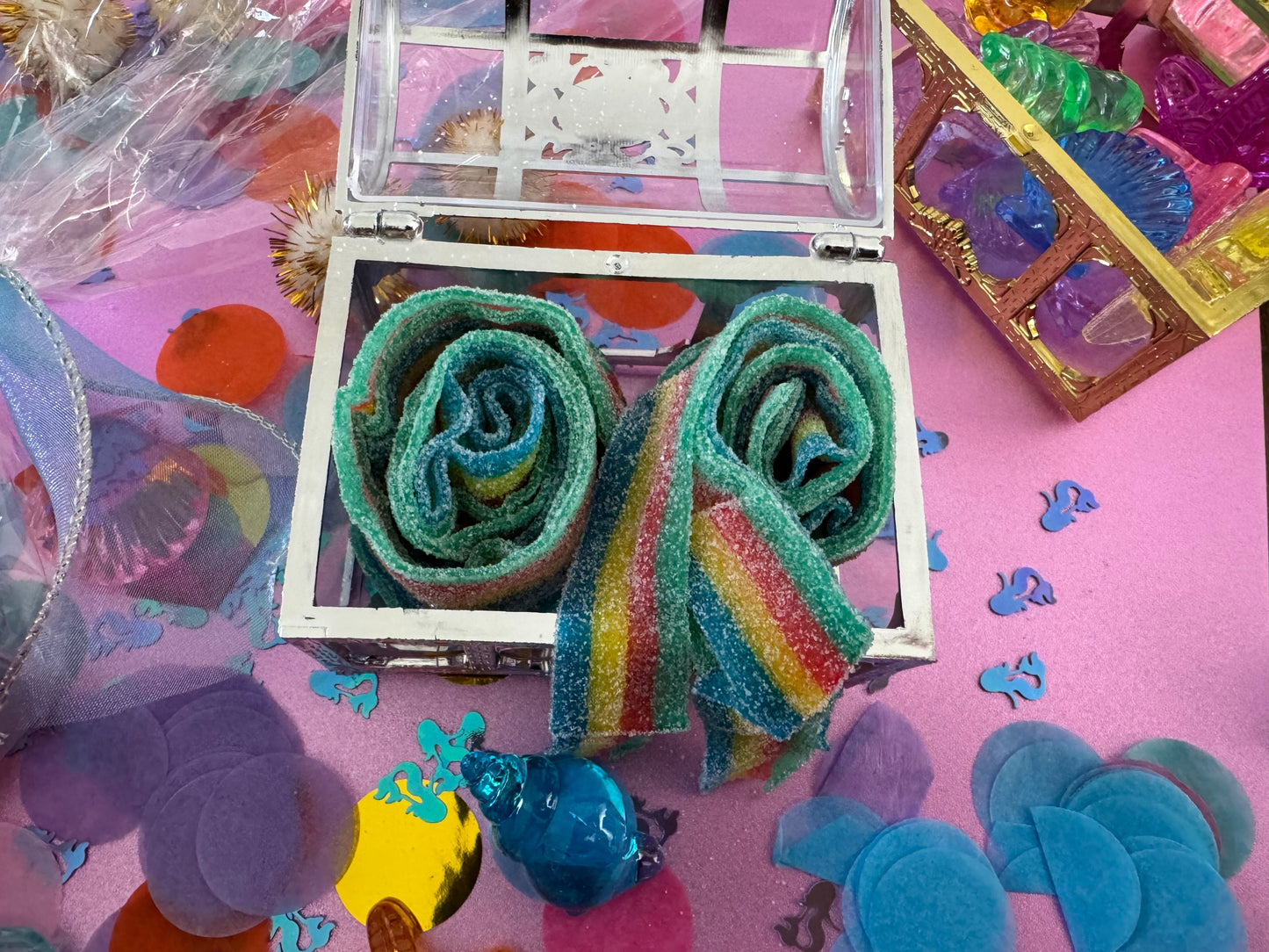 Magical Mermaid Candy favor in a gold or silver treasure chest, featuring rainbow mermaid tail candy with a sour punch. Perfect for under-the-sea or birthday party themes. Colors may vary from photos due to manufacturing differences