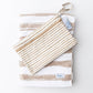 Child holding the Kenzie Beach Towel Brush Stripes Blue at the beach