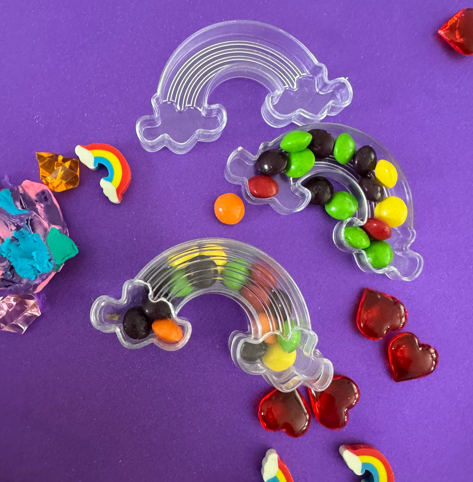 Trolls-themed birthday party favors featuring Poppy and Branch, enclosed in a rainbow-themed plastic box filled with Skittles. Perfect for celebrating and thanking guests, these candy favors are wrapped in cellophane with an optional thank you label. Great for playdates and available with other candy containers
