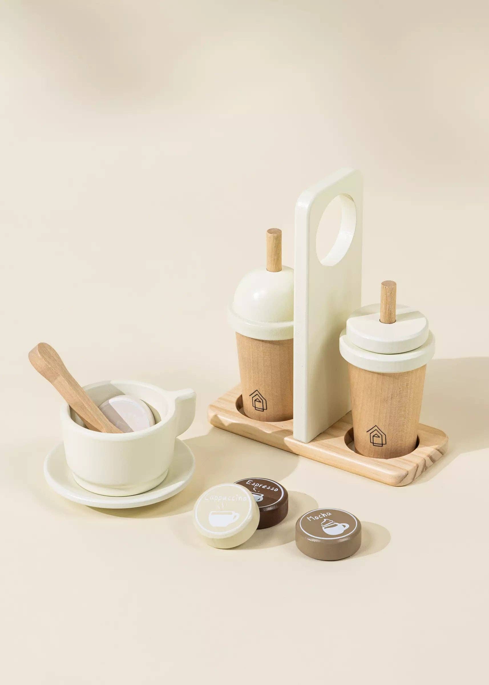 Wooden Coffee Maker Playset for kids with 4 coffee pods, cup, plate, spoon, cup holder, and 2 to-go cups. Perfect for imaginative play, allowing children to role-play as baristas, creating cappuccinos, lattes, and more. Encourages creativity and motor skills development.