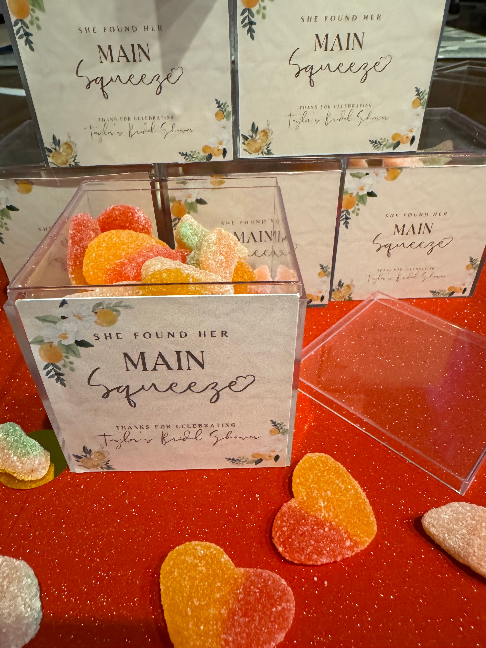 Baby shower favor cube with matching candy colors and custom name label.