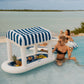 FUNBOY Floating Cabana Bar measuring nearly 6ft long, perfect for outdoor entertainers and summer parties. This inflatable drink station features a navy blue and white cabana stripe fabric sun shade that helps keep drinks and ice cold. With dual circular drink holders for ice or beverages and four additional cup holders, it’s ideal for mixing cocktails in the pool or setting up a pop-up drink station on a table.