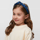 Indigo velvet kids' headband with 14k gold-plated dreidel charms and crystals, supporting Israel.